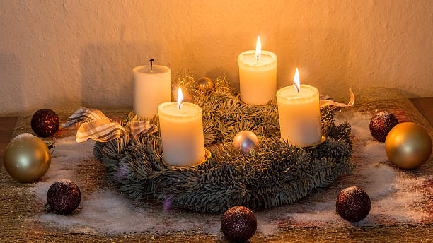 Advent Wreath 3rd Advent Festive wreath with three burning candles for the 3rd Advent advent candle wreath christmas stock pictures, royalty-free photos & images