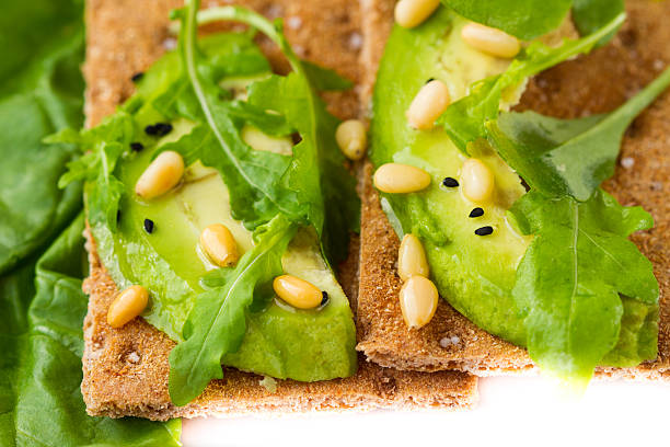 galleta crujiente con aguacate y roqueta - mashed portion small close up fotografías e imágenes de stock