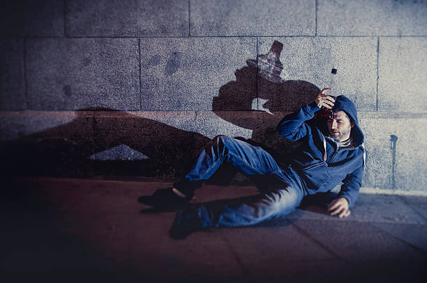 istock alcoholic grunge man on ground street corner drinking bottle 505652383