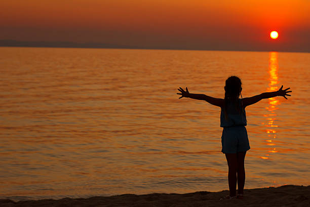 istock silhouette of a child on the beach 505653345