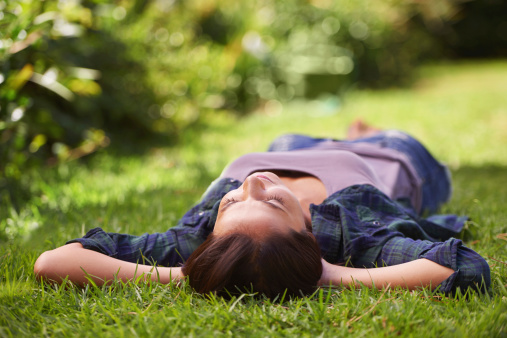Shot of an attractive young woman lying on the grass