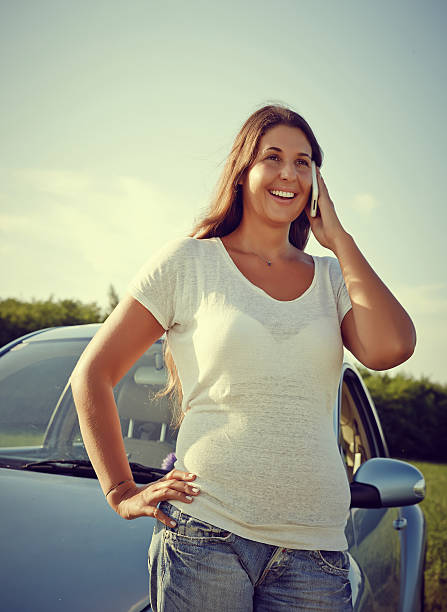 istock Young Driver Woman on the phone by car 505654405