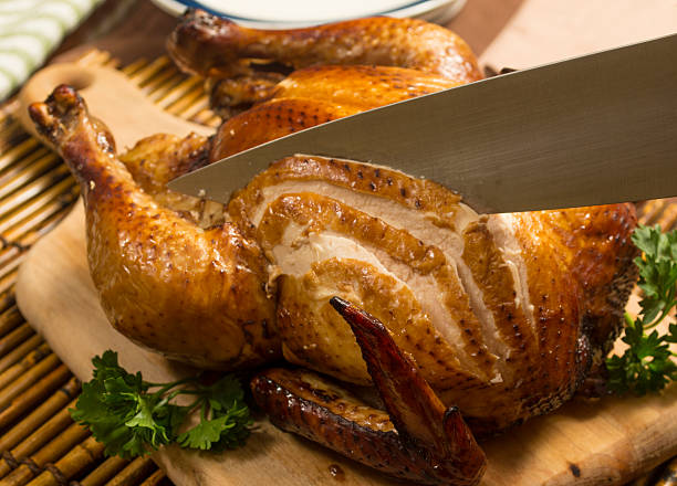 istock whole roasted chicken being carved 505654421