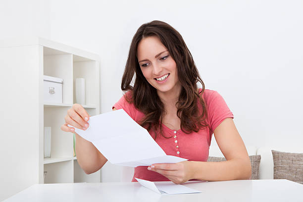 istock Happy Woman Reading Paper 505656647