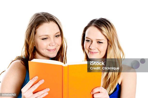 Looks Like A Fun Read Smiling Teenage Girls Sharing Book Stock Photo - Download Image Now