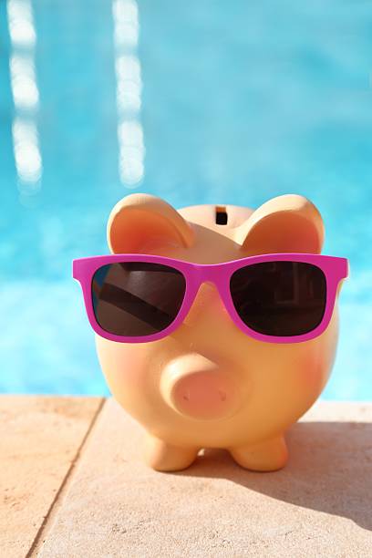 istock Summer piggy bank with sunglasses 505658287
