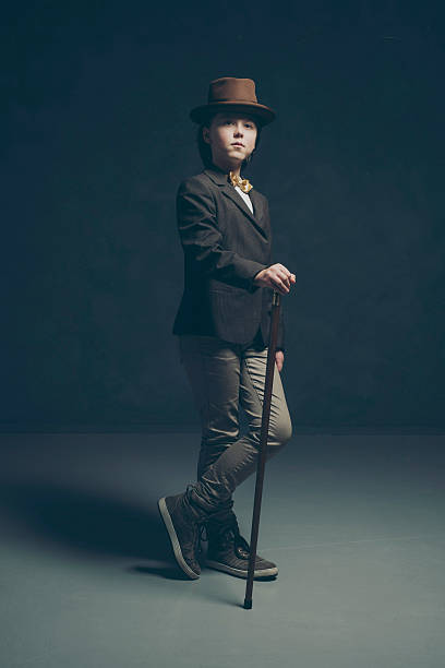 istock Boy wearing jacket and hat standing with cane. 505662760
