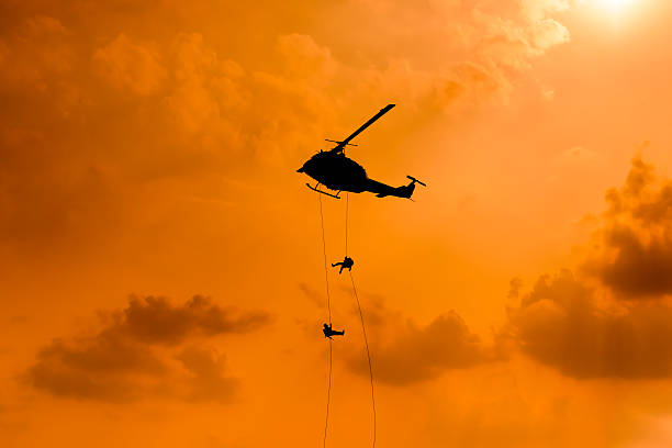 istock Silhouette of parachute and airplane on sunset background 505662986