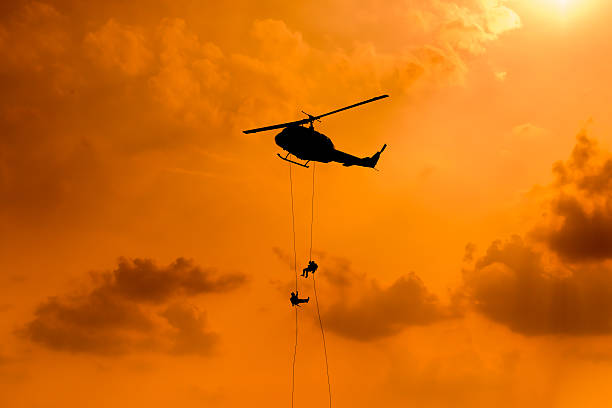 istock Silhouette of parachute and airplane on sunset background 505663086