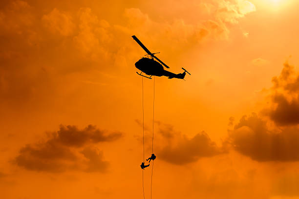 istock Silhouette of parachute and airplane on sunset background 505663200