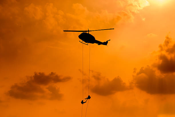 istock Silhouette of parachute and airplane on sunset background 505663228