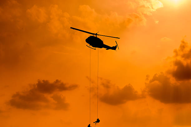 istock Silhouette of parachute and airplane on sunset background 505663292