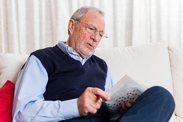 istock older senior man at home reading enjoying retirement 505663346
