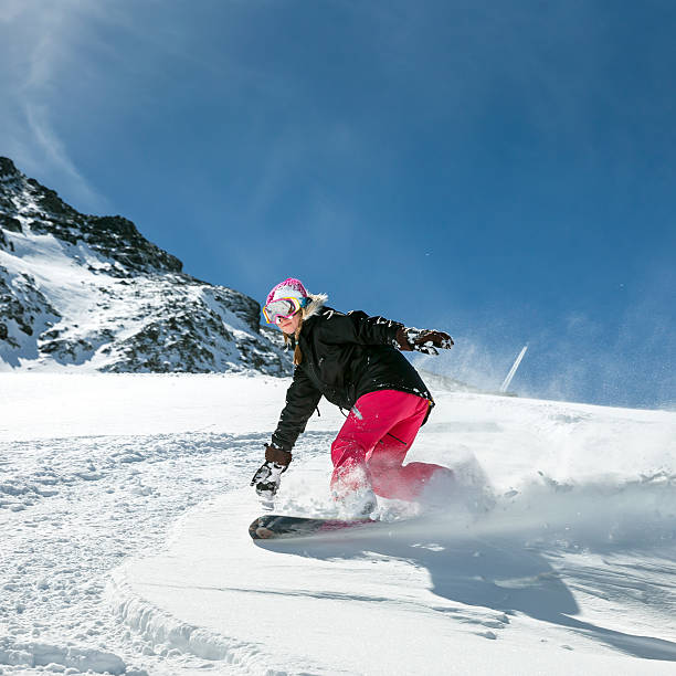 istock Woman snowboarder in motion in mountains 505663362