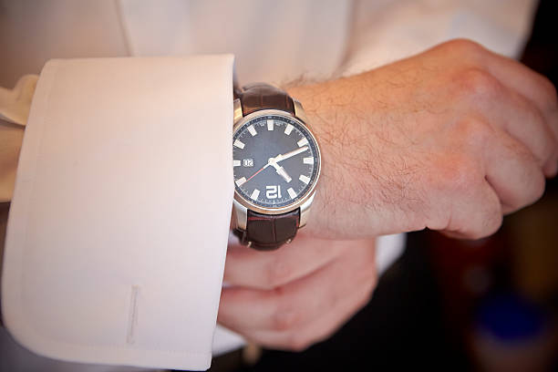 istock A man putting on his shirt with a wristwatch 505666706