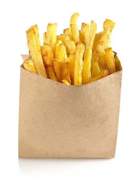 Photo of French fries in the paper bag isolated on white