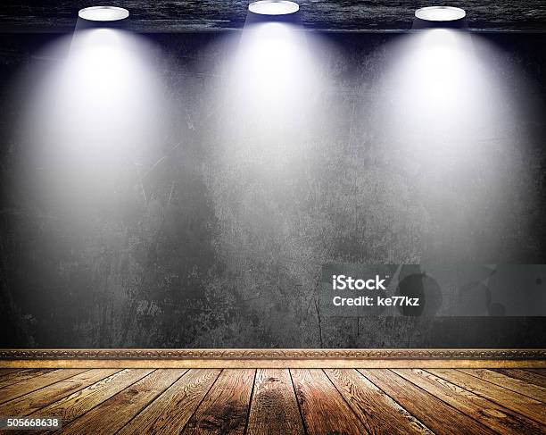 Black Grunge Wall With Three Lamps And Old Wooden Floor Stock Photo - Download Image Now