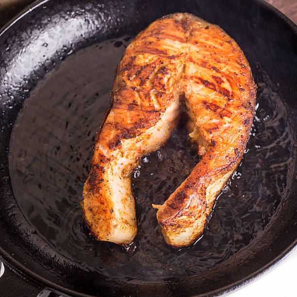 istock Roasting salmon steak on grill pan 505668842