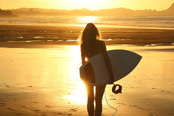 istock Surfer girl at sunset 505669042