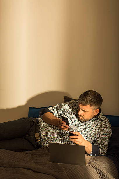 istock Worried man lying in bed 505669916