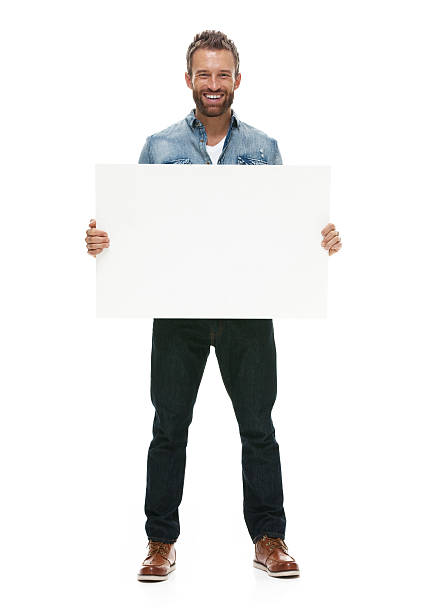Smiling casual man holding placard