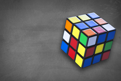 Turku, Finland - January 19, 2016: An isolated photo of a Rubik's Cube with chalk board backround. Rubik's cube was invented by Hungarian sculptor and professor Erno Rubik in 1974.