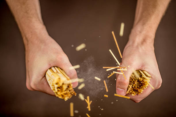 Breaking Spaghetti with Hands, Close up stock photo