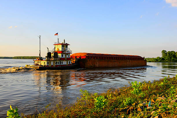 Greenville, MS, USA - June 10, 2015: Tugboat pushing barges along the great Mississippi river seen here at Greenville MS