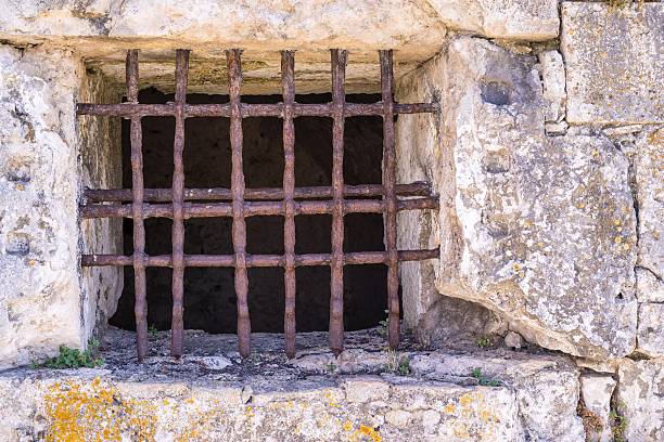 istock old window with a rusty lattice on stone wall 505684396