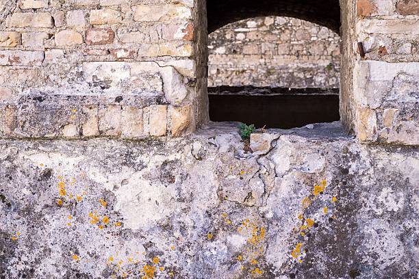 istock part of ancient fortress with a loophole 505684732