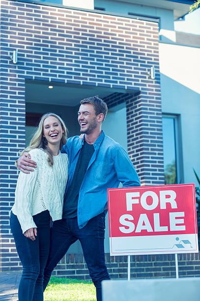 istock Couple standing in front of a new home. 505685154
