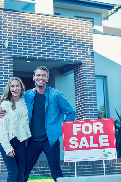 istock Couple standing in front of a new home. 505685306