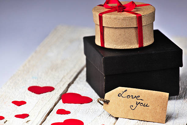 istock Gift boxes and heart papercut on wooden background 505686600