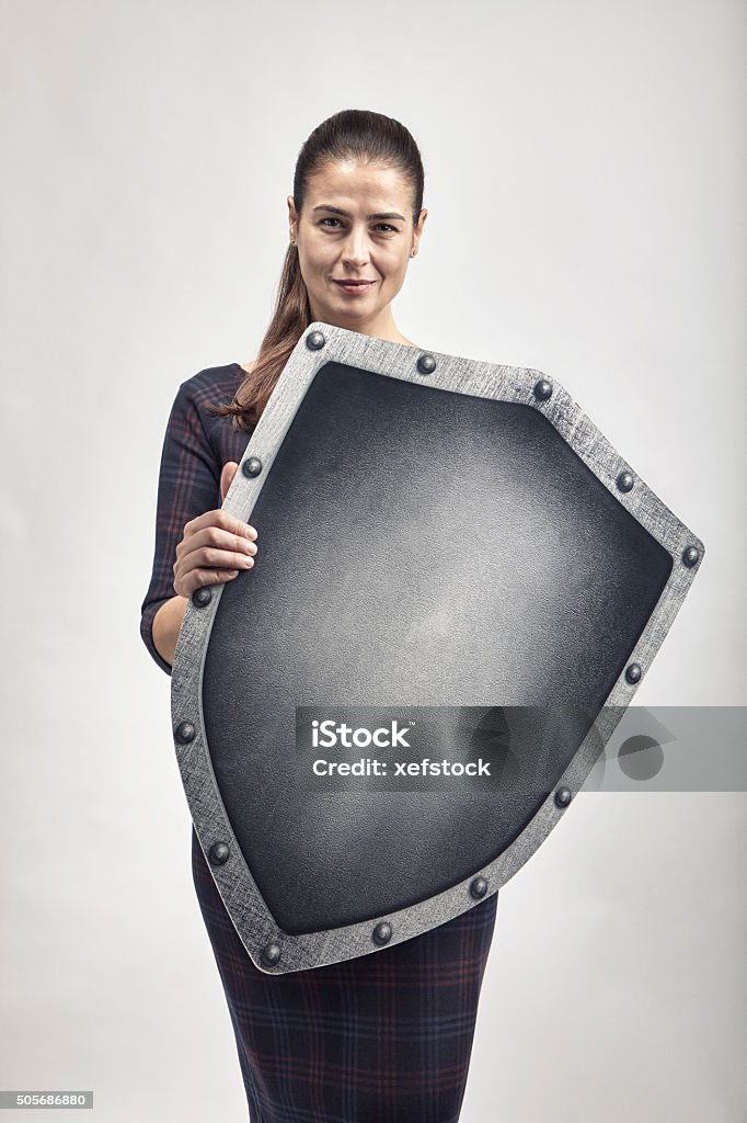Woman protecting herself with a shield Shield Stock Photo