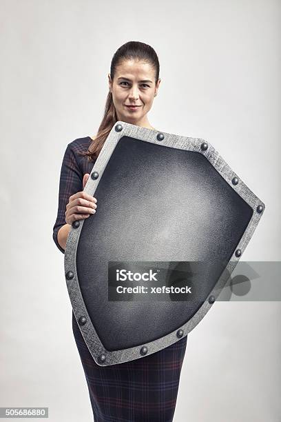 Woman Protecting Herself With A Shield Stock Photo - Download Image Now - Shield, Shielding, Immune System