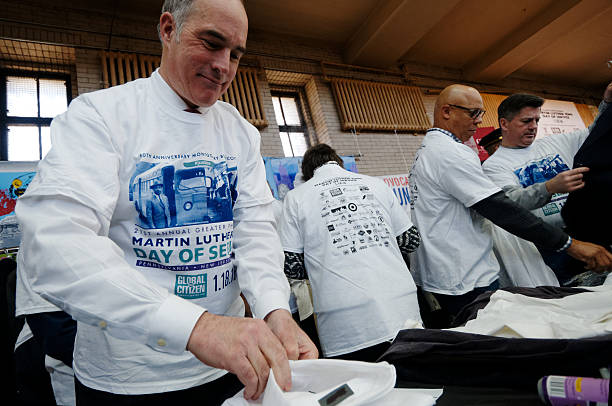 Sen. Casey volunteers for MLK Day of Service Philadelphia, PA, USA - January 18, 2016; Sen. Bob Casey, joined by other elected officials, community members volunteers at a gently used business attire sorting project during the 21st Martin Luther King Day of Service in Philadelphia, PA. martin luther king jr day stock pictures, royalty-free photos & images