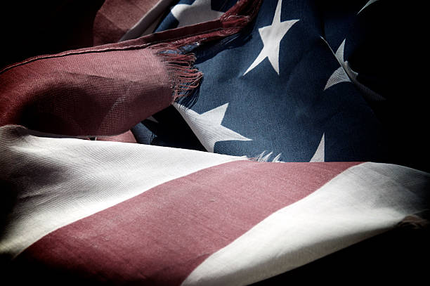 istock old and tattered American flag 505692156