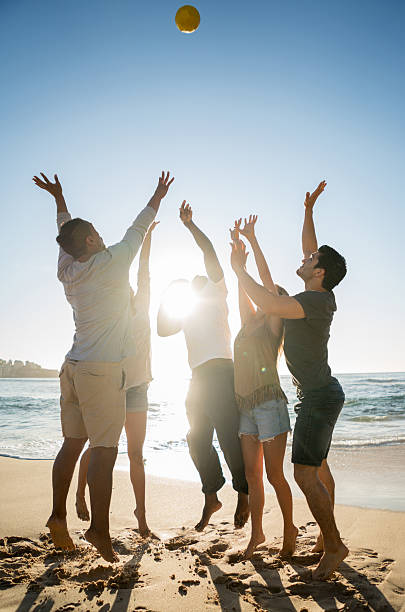istock Young people playing beach volleyball 505692336