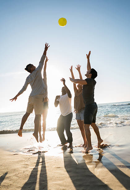 istock People playing volleyball at the beach 505692422