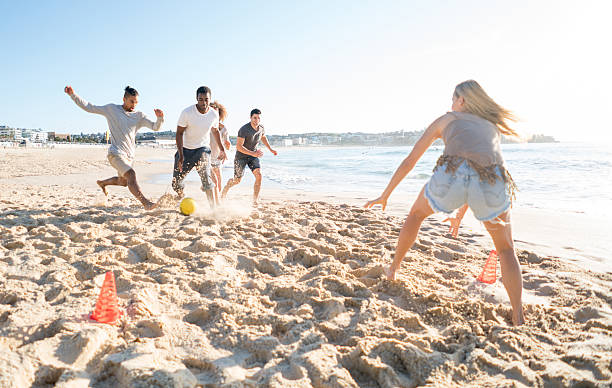 istock People playing football at the beach 505692656