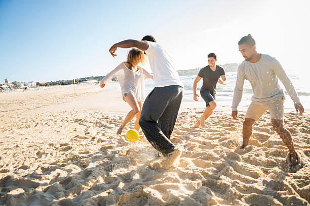 istock Friends playing soccer at the beach 505693614