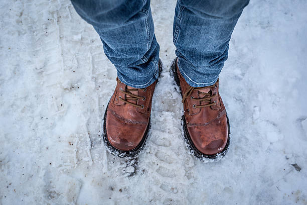 istock Human feet in brown colored boots 505693784