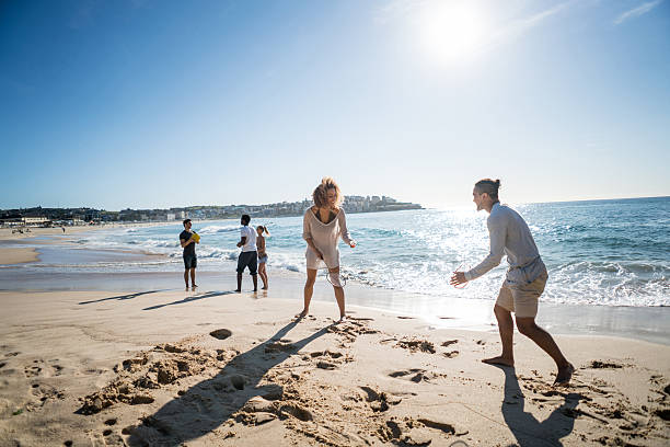 istock Couple playing badminton at the beach 505694516