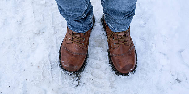 istock Human feet in winter boots on snow 505694680