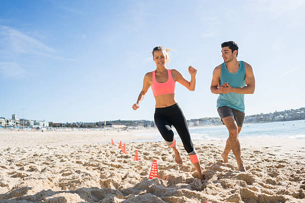 istock Young couple exercising at the beach 505694732