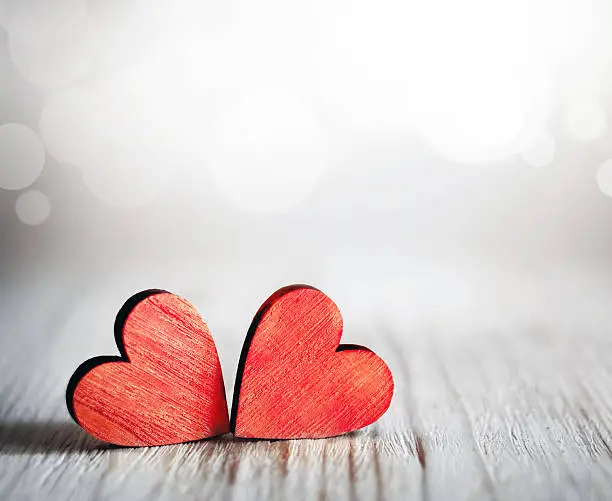 Photo of Valentines day. Red hearts on wooden background