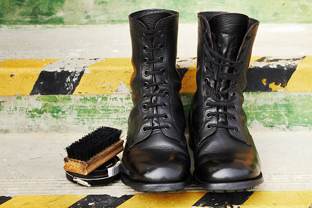 Ready for parade detail Shot of a pair of polished army boots sitting on some steps shoe polish photos stock pictures, royalty-free photos & images