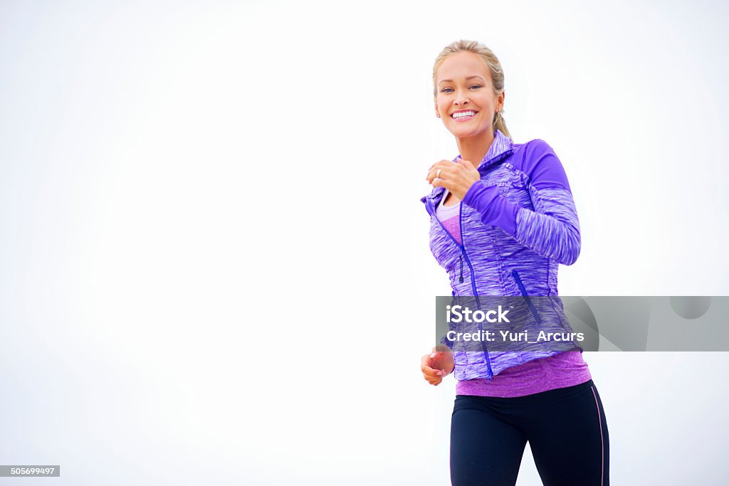 Keeping herself in perfect shape! An attractive young woman out for a run 20-29 Years Stock Photo