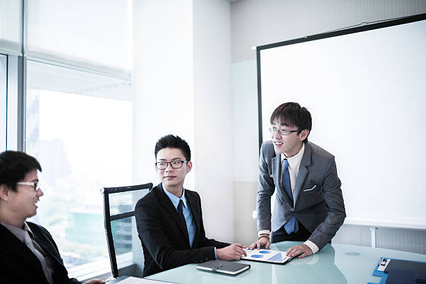 istock businessman giving a presentation to his colleagues 505700251