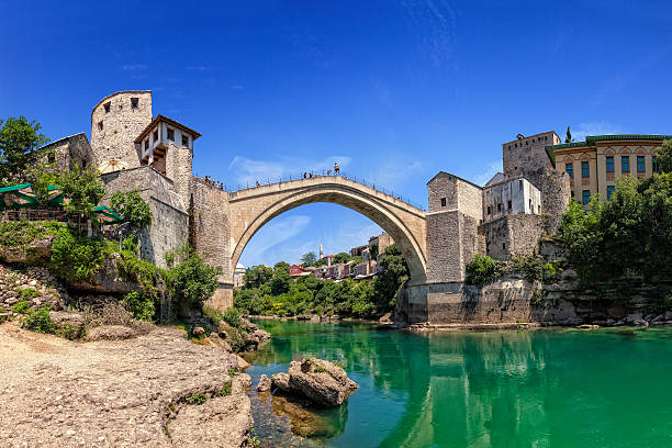 Famous Old Bridge in Mostar The Old Bridge in Mostar with emerald river Neretva. Bosnia and Herzegovina. mostar stock pictures, royalty-free photos & images